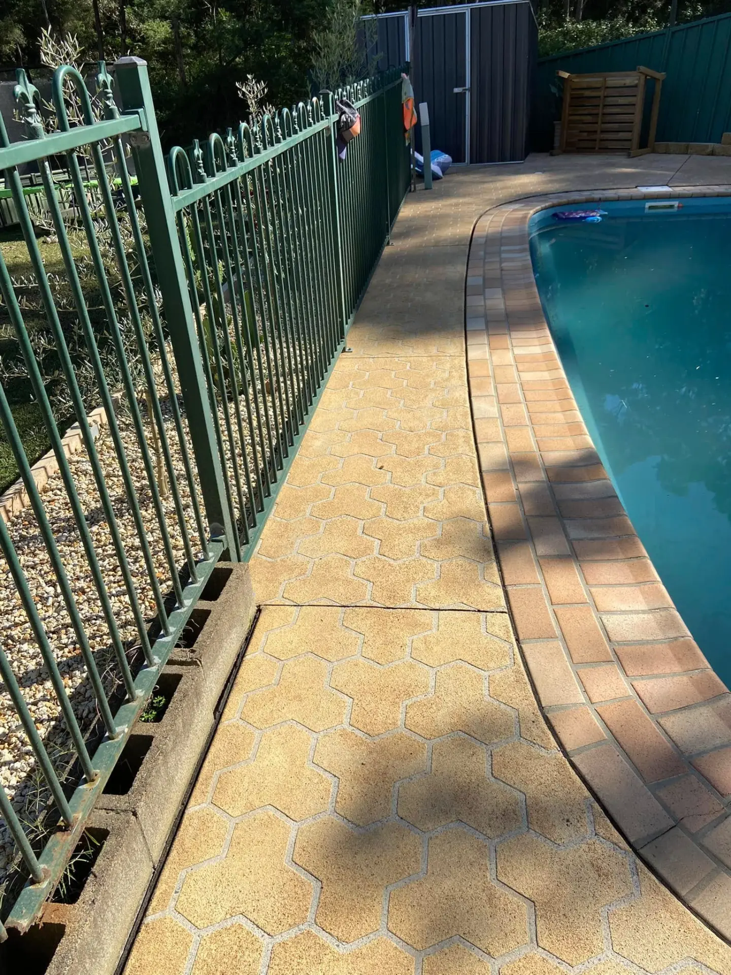 The same pool surround pavers after pressure cleaning, sandstone colour restored
