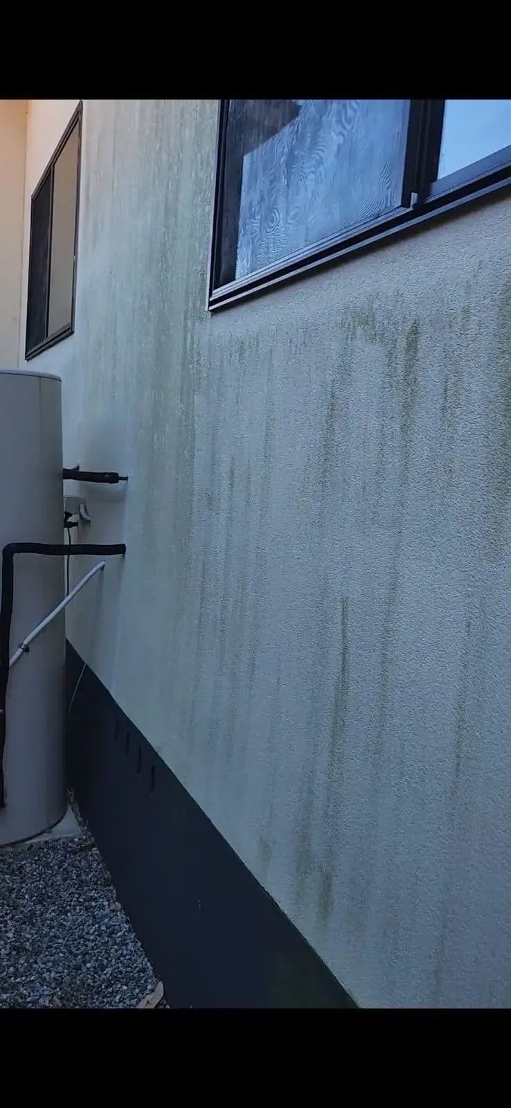 Close-up of a dirty rendered exterior wall before cleaning